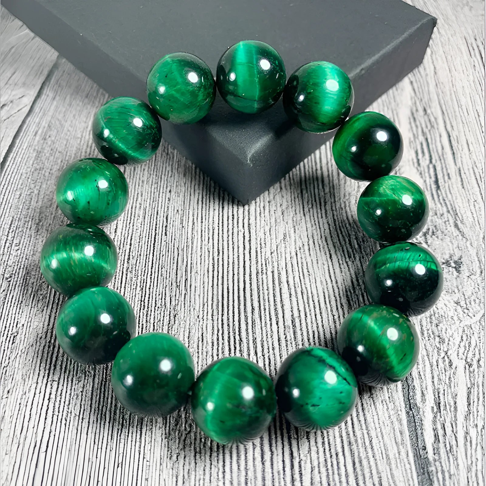 Green tiger eye stone bracelet with geometric polished beads showing banded natural patterns