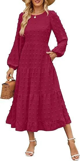 A woman wearing a beige high waist long sleeve dress with ruffle details on a autumn day.