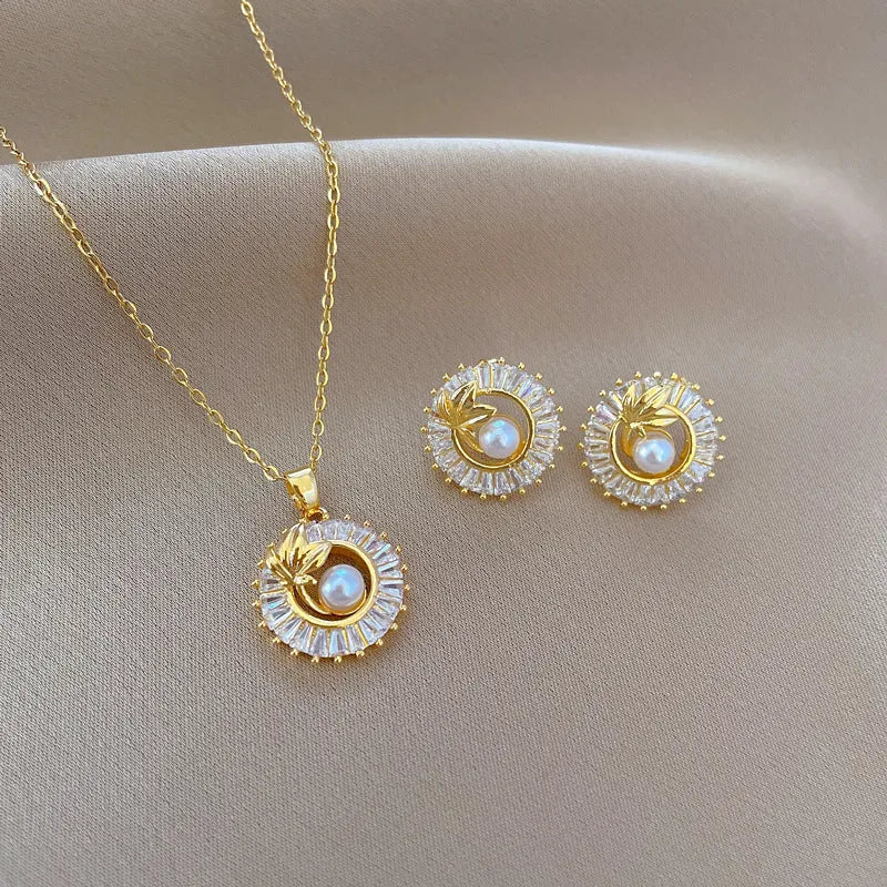 Titanium steel geometric jewellery set with round ring, square pendant necklace, and leaf-shaped stud earrings on a silver-tone chain.