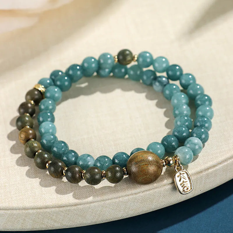 Natural stone blue beaded bracelet for women with sandalwood accents and Fu character motif