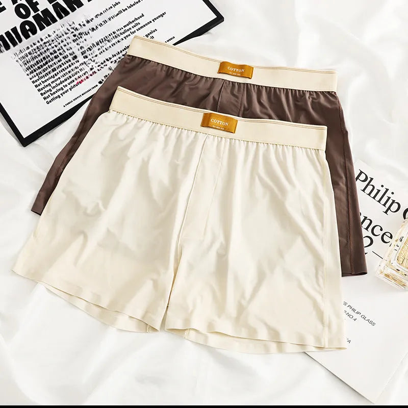 Pack of three men's solid colour loose fit ice silk boxer shorts on a mid waist.
