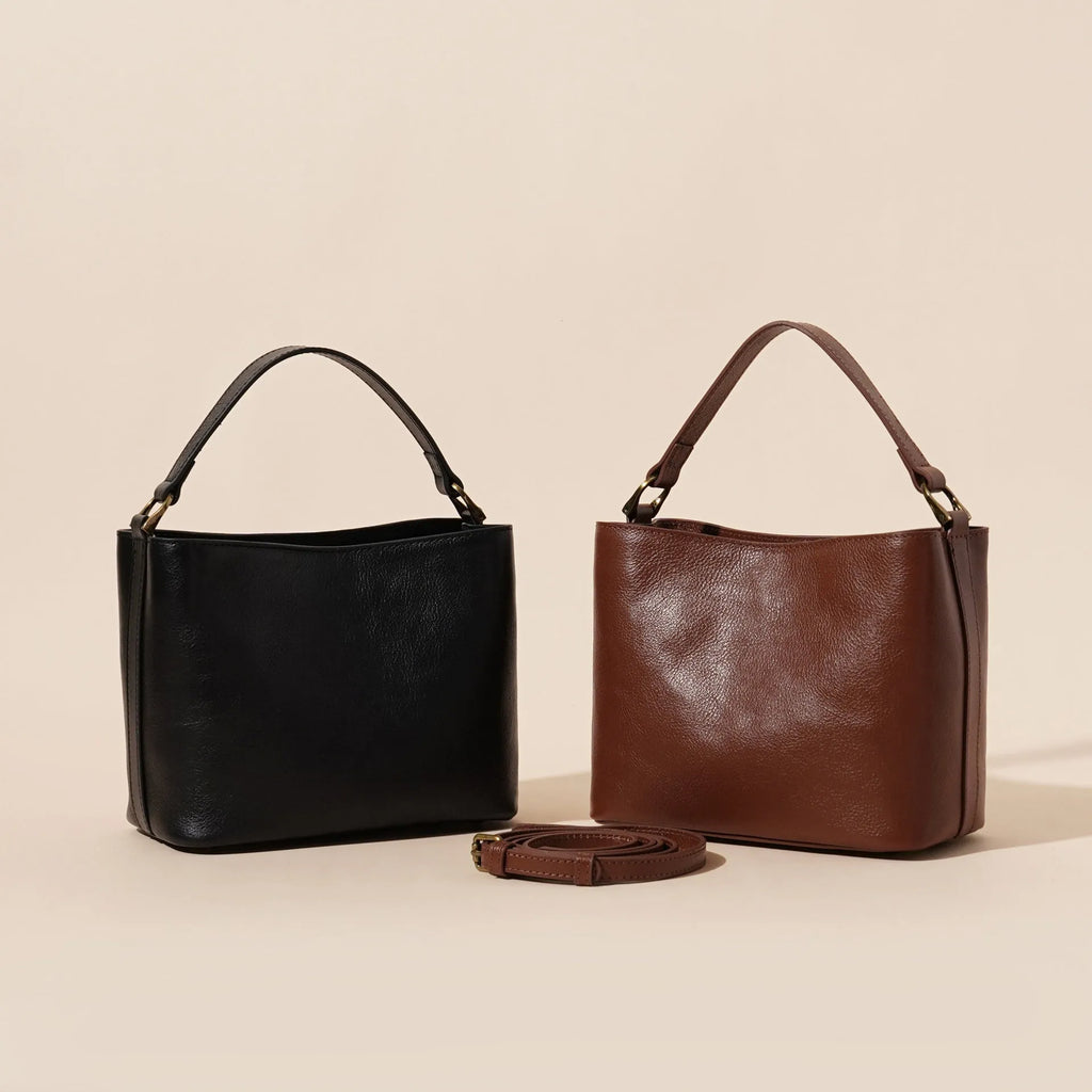Sugar brown genuine leather women's shoulder handbag with sewing thread detailing on a white background