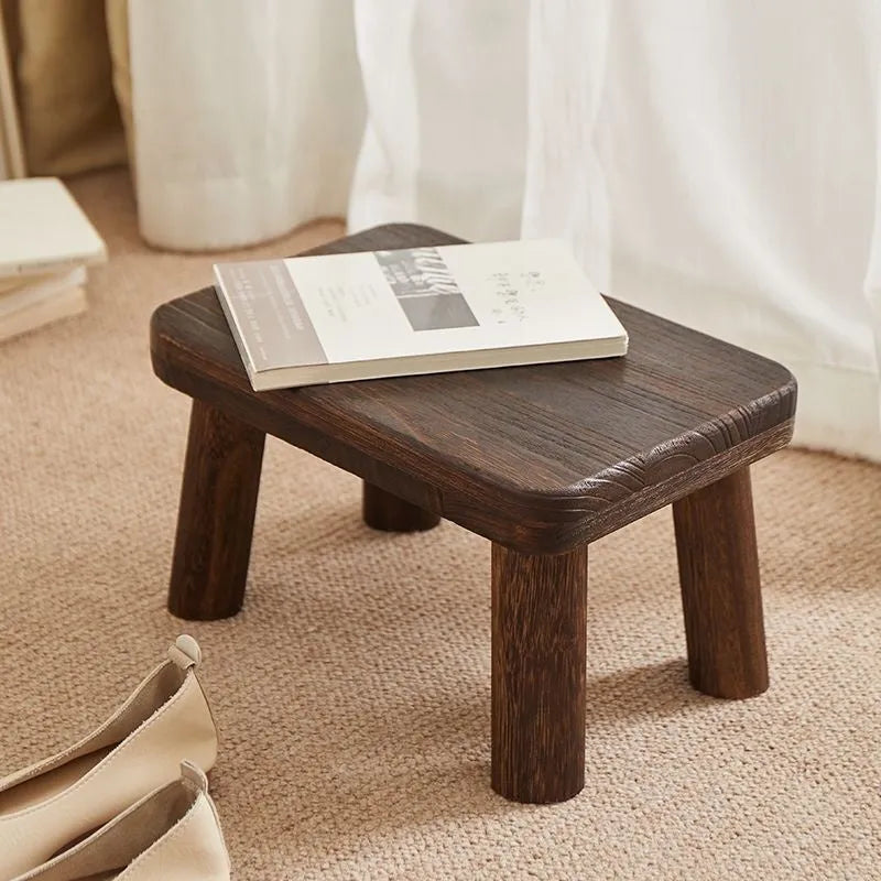 Solid wood distressed finish changing stool with bracket structure.
