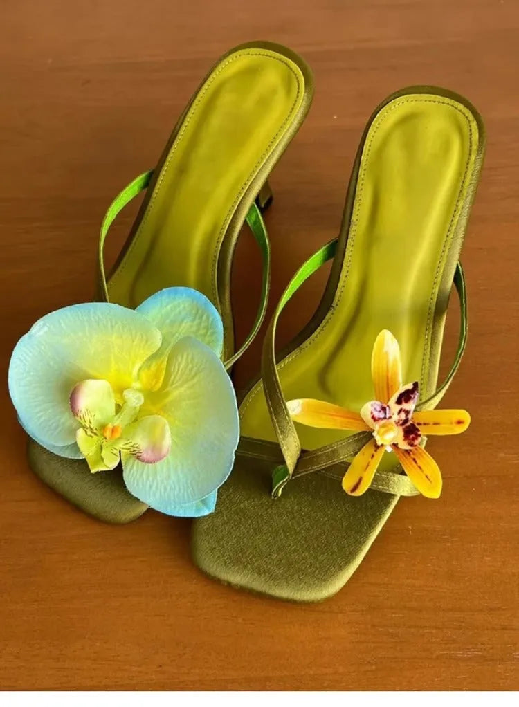 Handmade women's high heel semi-slipper sandals with asymmetric flower detail, calf leather upper, square toe, and EVA sole in black, green, pink, and white