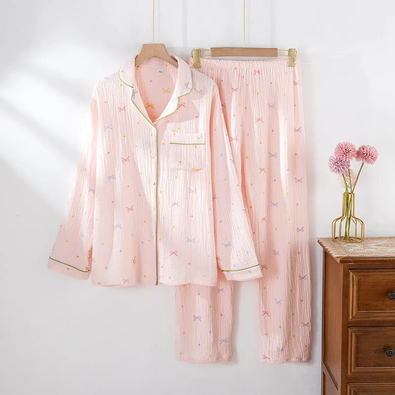Women's long sleeve cotton pyjama set in pink, featuring a simple casual style top and trousers.