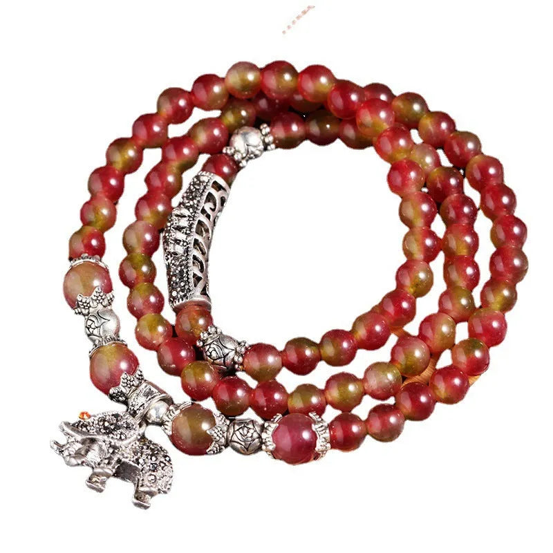 Handmade bracelet with geometric watermelon crystal beads and Chinese knotting in 6mm or 8mm size.