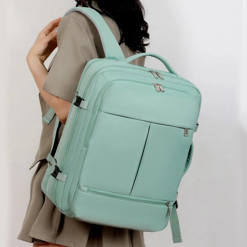 Waterproof Oxford cloth backpack for a 15.6 inch laptop, shown in multiple colours with visible pockets and zippers.