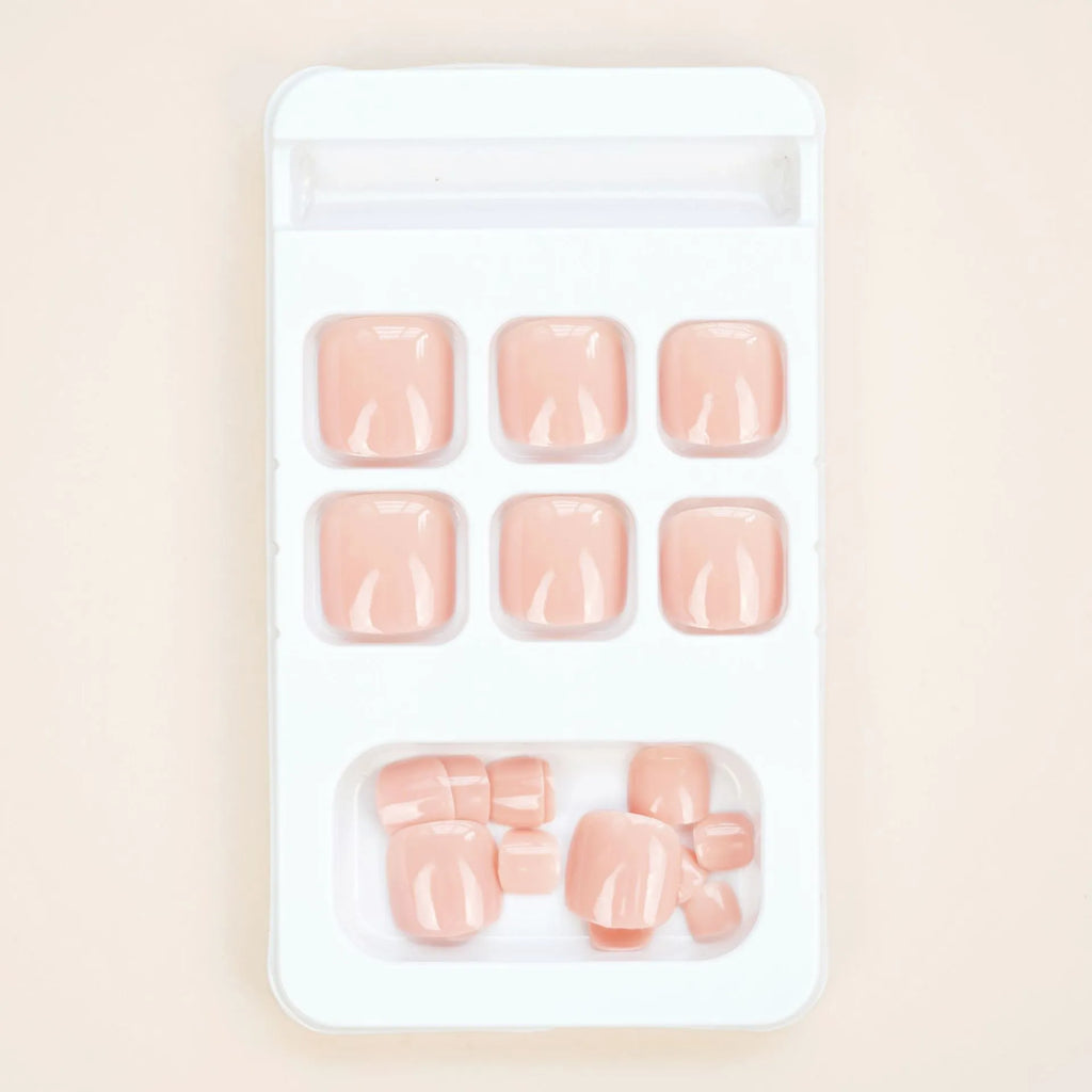 J-52 skin colour plastic false toenail stickers and glue set for cosmetic application.