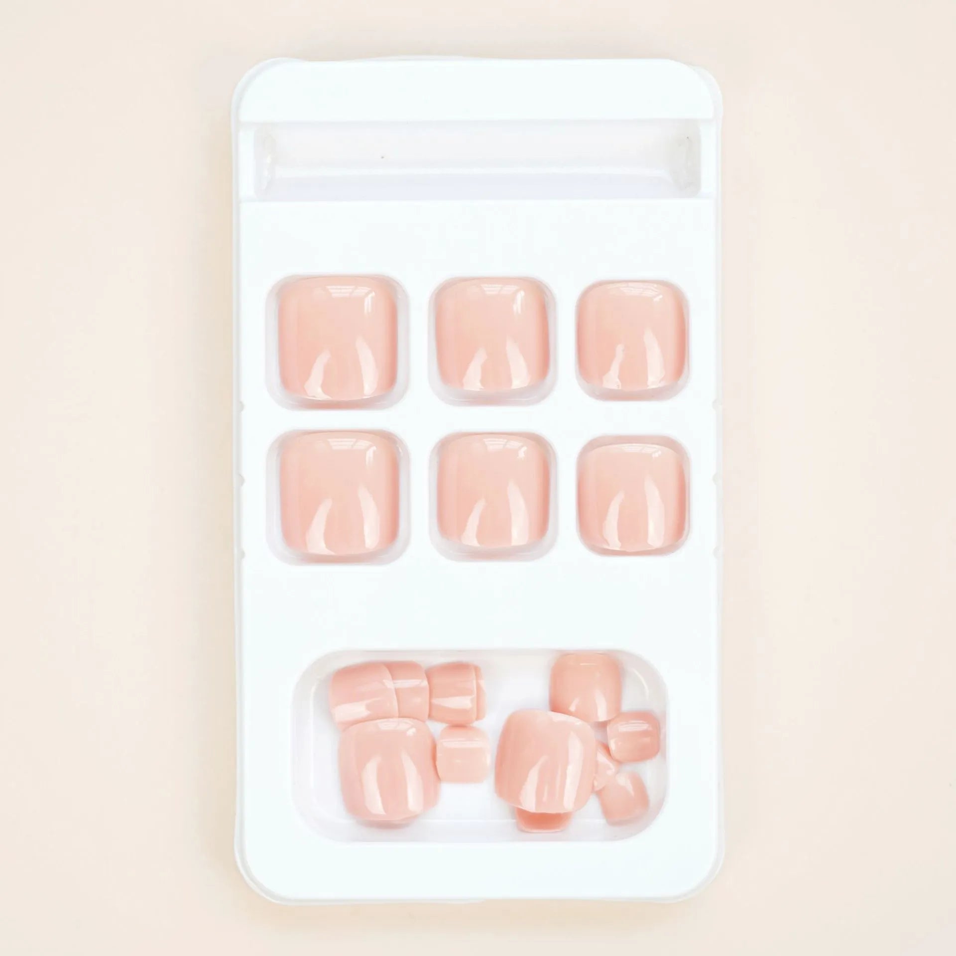 J-52 skin colour plastic false toenail stickers and glue set for cosmetic application.