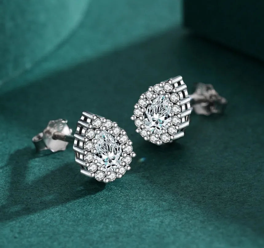 Silver waterdrop shaped ear studs with diamond-cut finish on 925 sterling silver