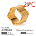 Stainless steel ring with a wide geometric wave design in a gold or silver finish.