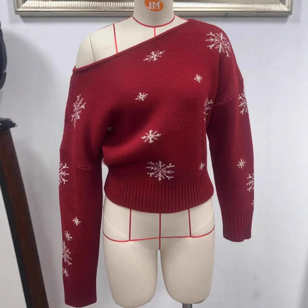 Women's red snowflake jacquard boat neck pullover sweater with long sleeves and crocheted flower details on a white background