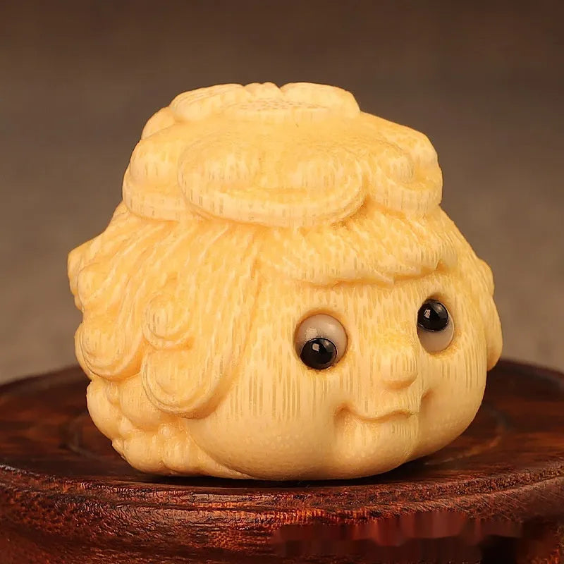 Solid bamboo carving of a cute Golden Toad Princess ornament on a white background.