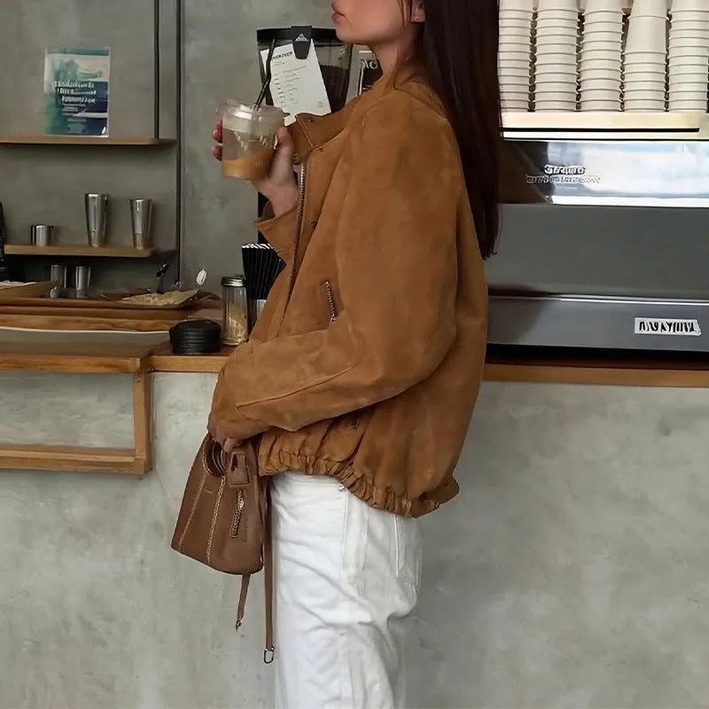 Loose fit solid colour retro jacket with long sleeves on a hanger.