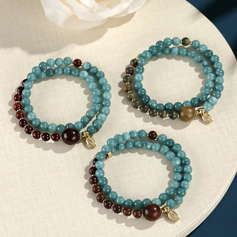 Natural stone blue beaded bracelet for women with sandalwood accents and Fu character motif