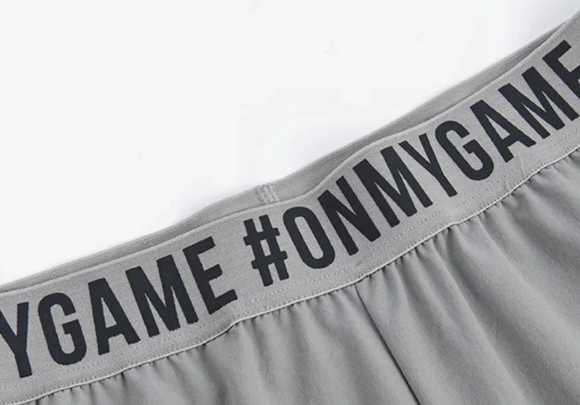 Loose cropped sports pants with printed waistband in grey, black, and blue colour options