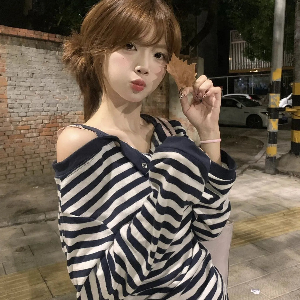 Dark blue women's oversized long-sleeve T-shirt with stripes, buttons, and embroidery details.