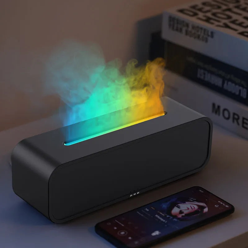 Black aroma diffuser with glowing orange flame effect and colour-changing LED base on a wooden table