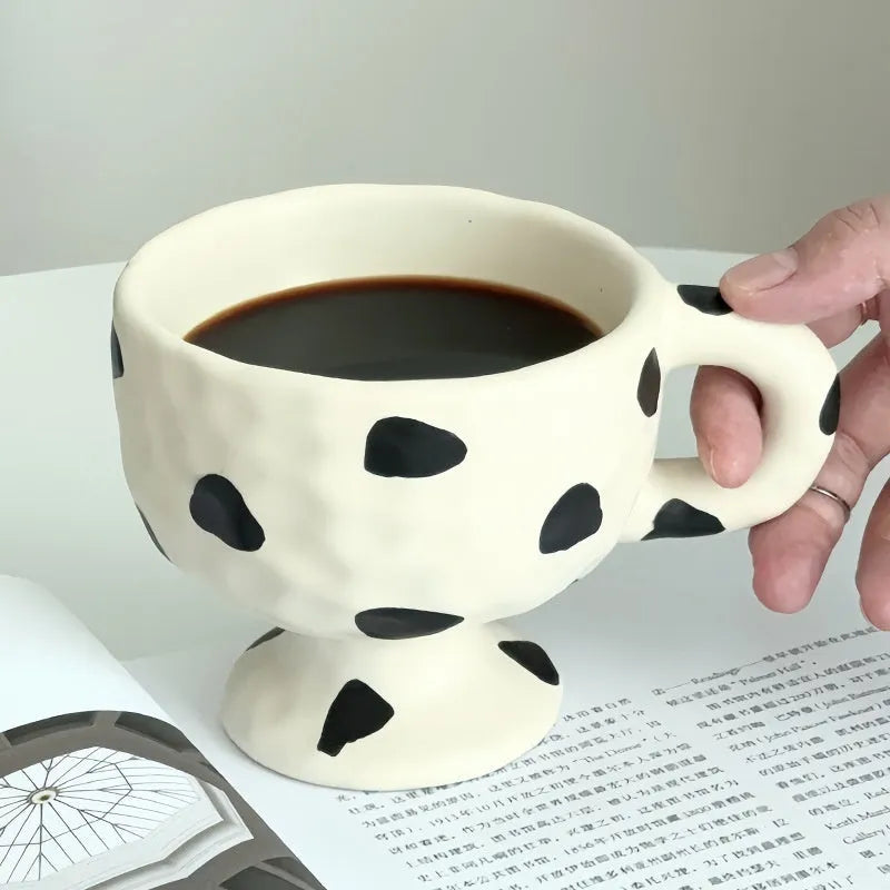 Hand-pinched irregular ceramic mug in solid colour with modern simplicity design