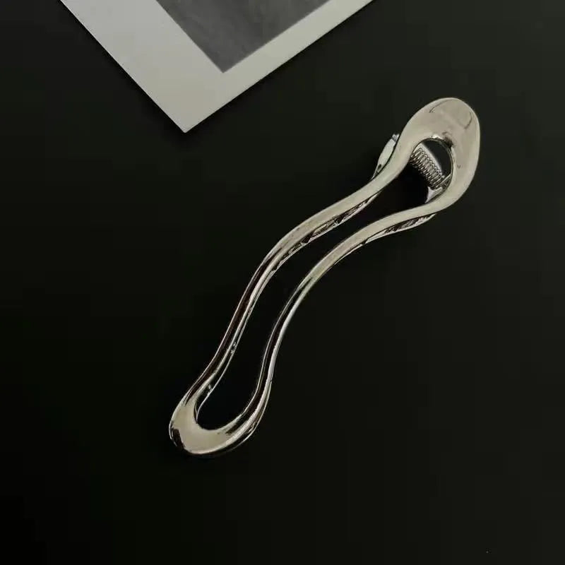 Women's zinc alloy hair barrettes in gold and silver with arc, square, and triangle shapes