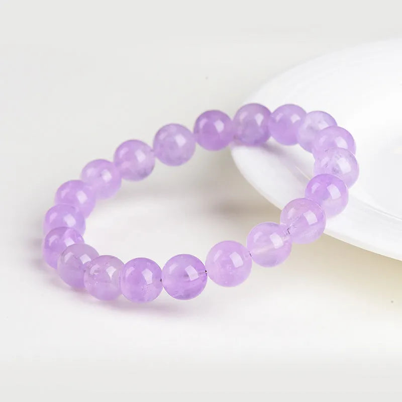 Lavender amethyst crystal bracelet with round beads showing water ripple pattern in light purple colour