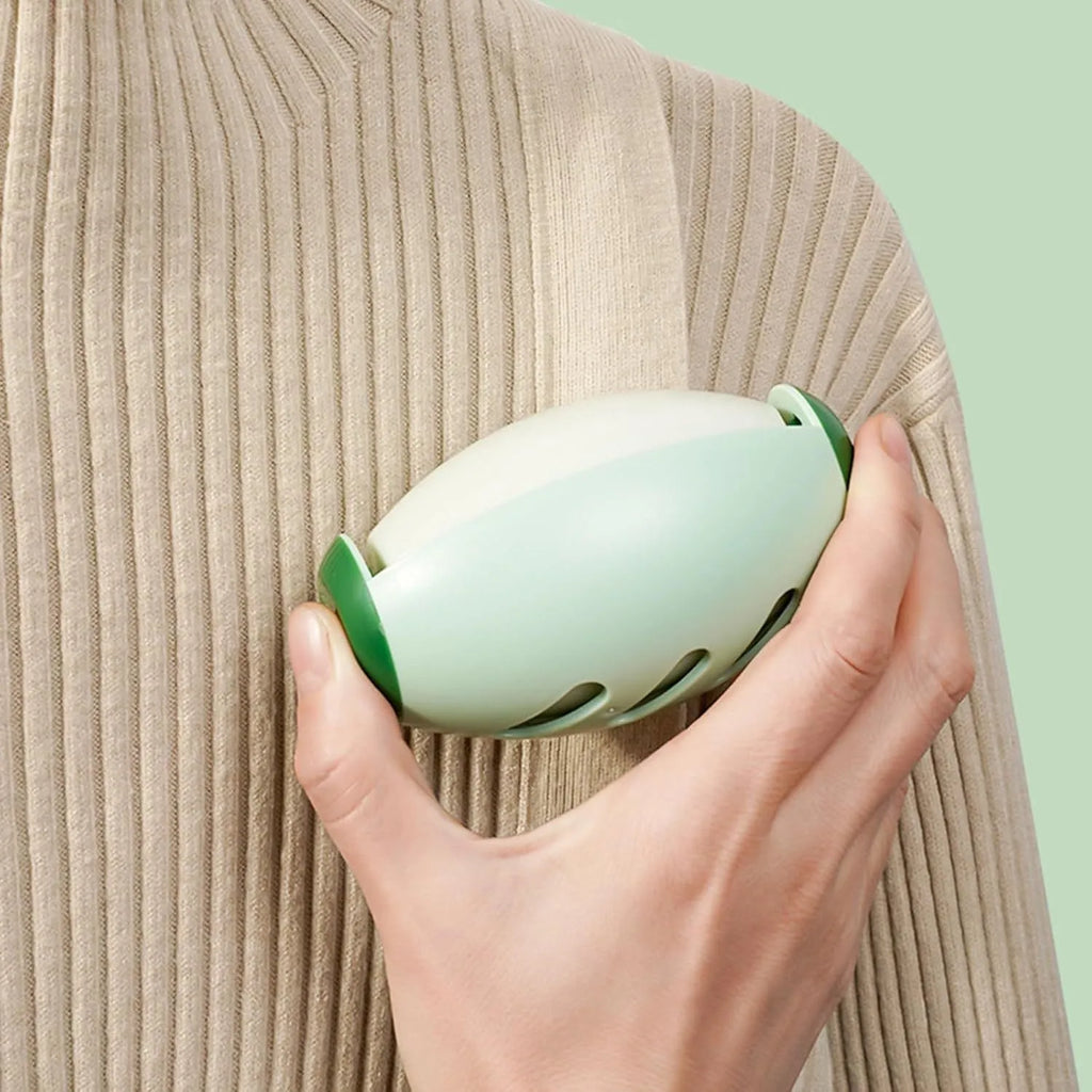 Green and white reusable gel lint roller ball for pet hair removal from clothes and furniture