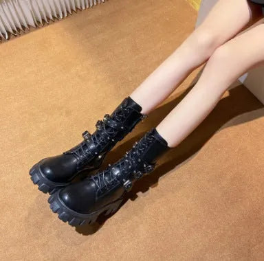 Women's black knee-high boots with metal buckle straps and a side zipper closure.