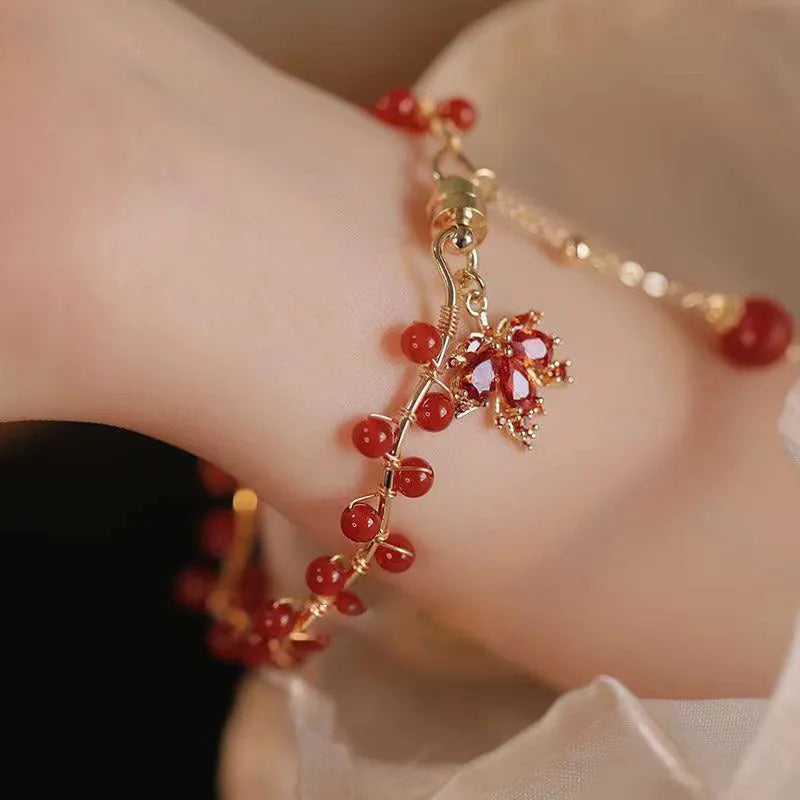 Red ginkgo leaf magnetic bracelet in alloy with electroplated finish on white background