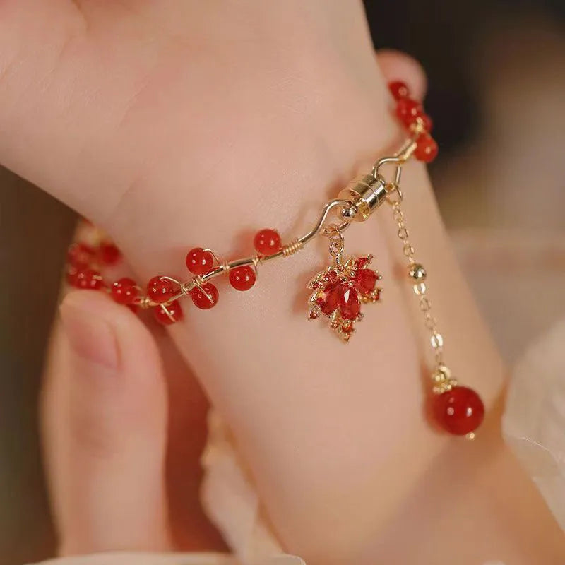 Red ginkgo leaf magnetic bracelet in alloy with electroplated finish on white background