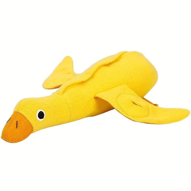 Yellow plush teddy dog toy with a attached duck doll and visible treat pockets on a white background.