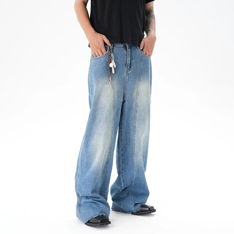 Light blue wide leg machete jeans with vintage washed denim finish, zip-fly closure, cut wash effect