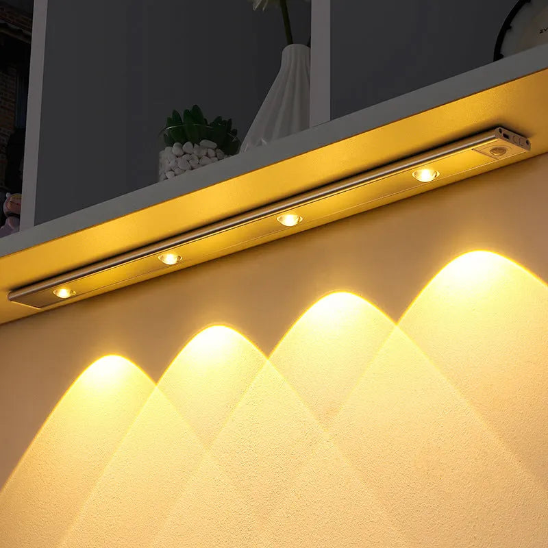 Ultra-thin USB LED night light with motion sensor in silver, aluminium body, 20 cm length, mounted inside a kitchen cabinet
