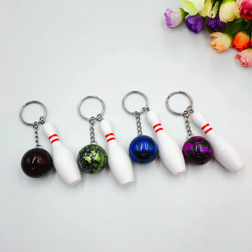 Mini PVC metal bowling ball keychain pendant in blue, dark red, green, or purple.