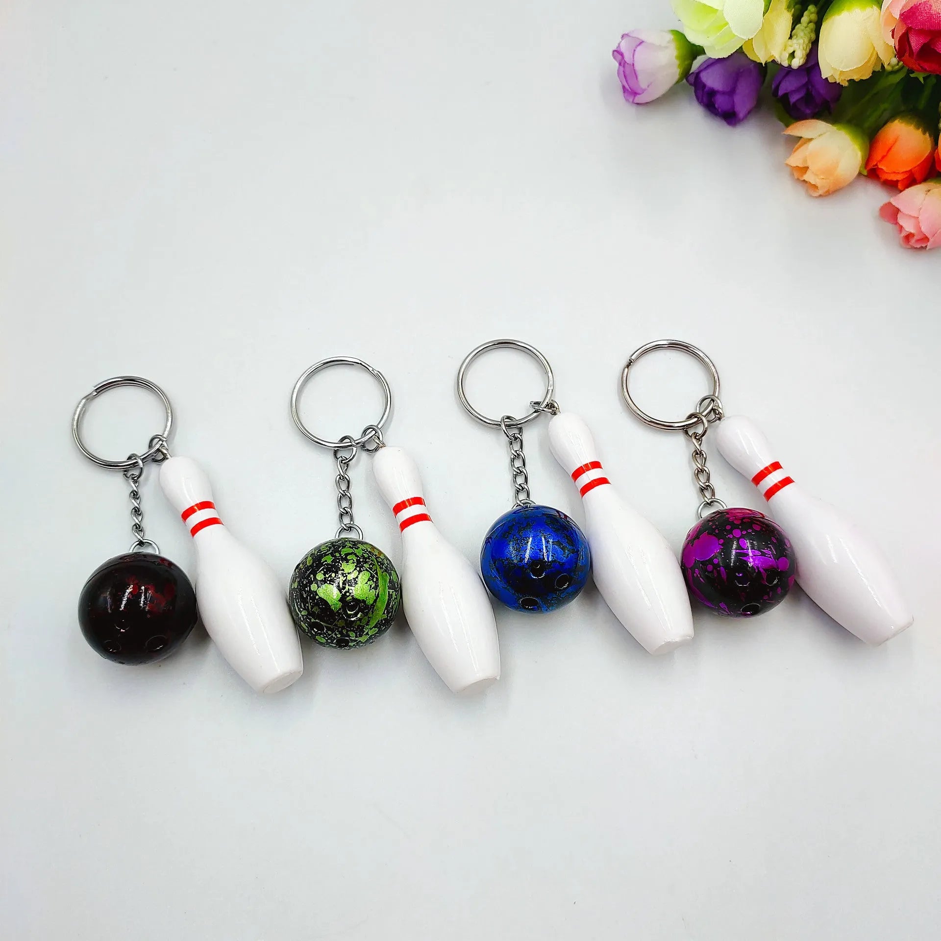 Mini PVC metal bowling ball keychain pendant in blue, dark red, green, or purple.