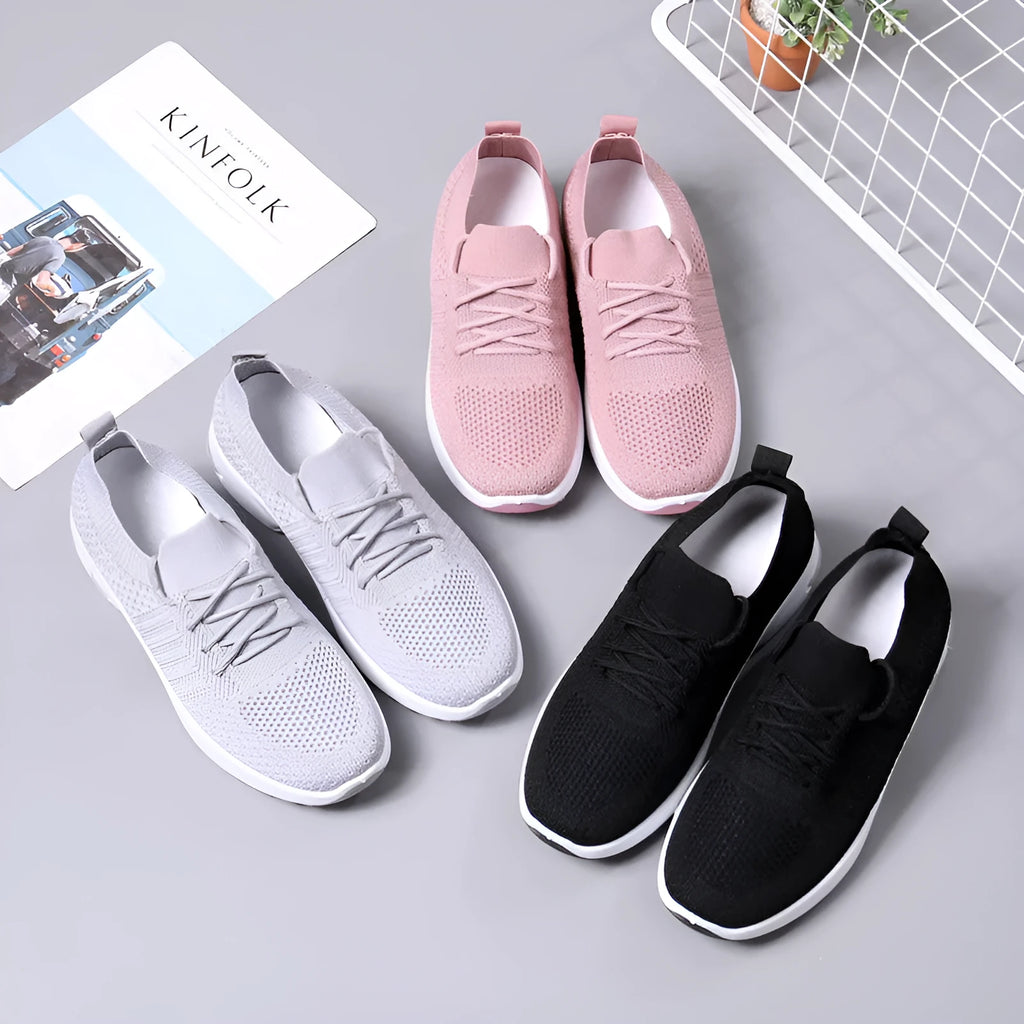 Women's black mesh casual sneakers with a round toe and white lace-up front.