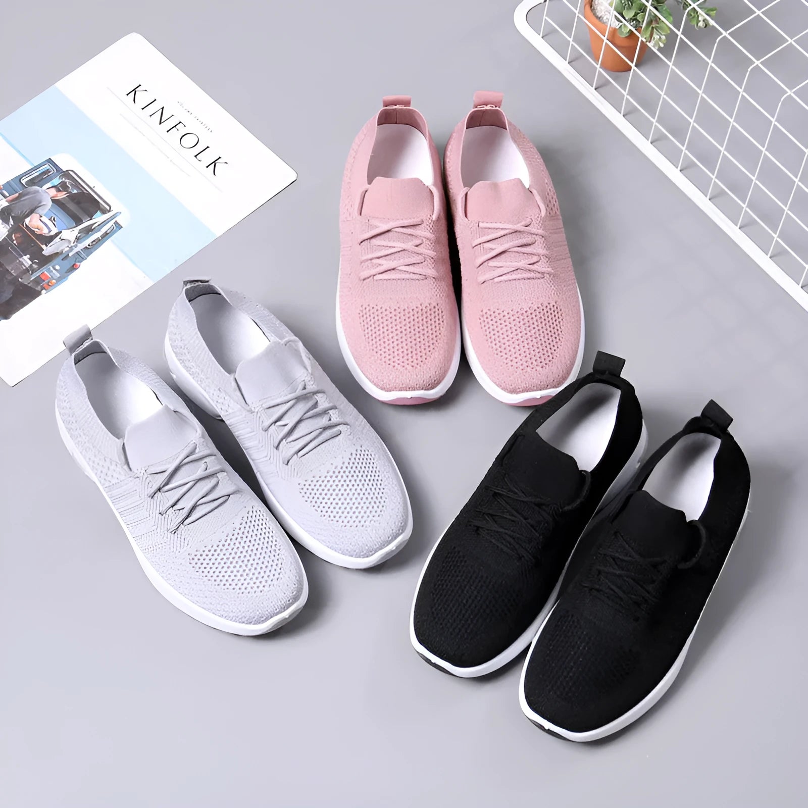 Women's black mesh casual sneakers with a round toe and white lace-up front.