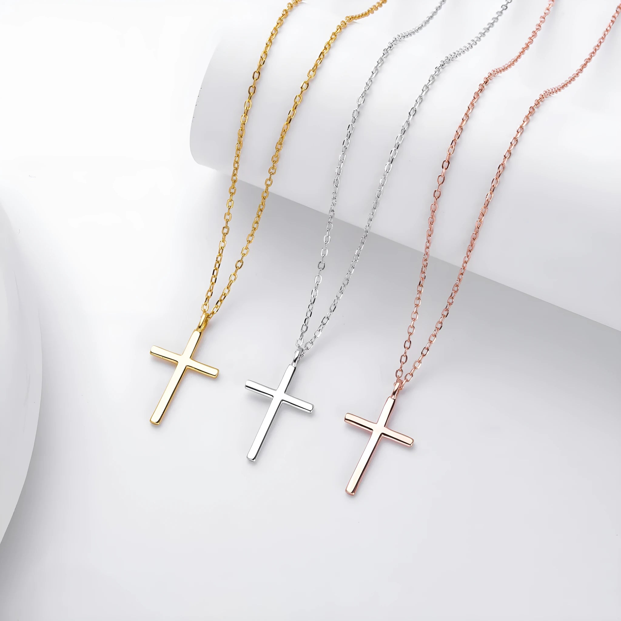 Simple glossy cross pendant on a sterling silver O-chain necklace.