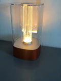 Rose gold LED touch atmosphere light with Auspicious Cloud pattern on a bedside table, USB charging cable included