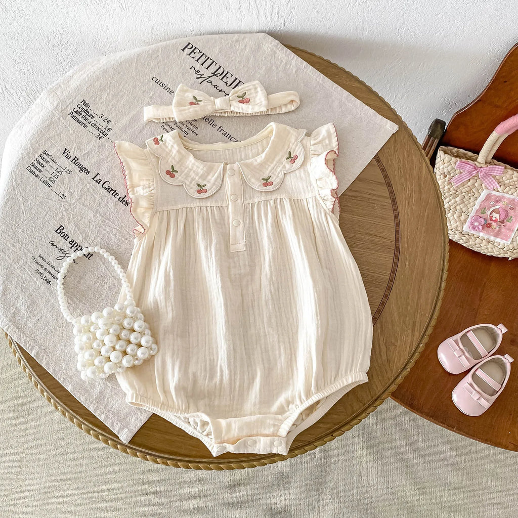 Summer cotton baby jumpsuit in apricot with double-breasted closure and matching hair band