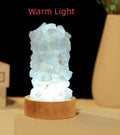 Natural amethyst vug tooth flower mini night light USB plug-in crystal lamp with warm light option on a wooden surface