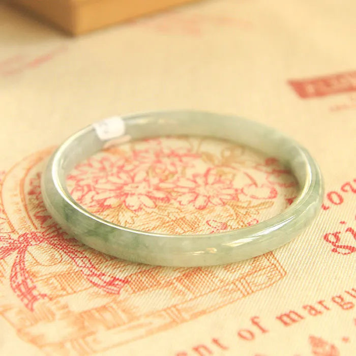 Green jade waxy bracelet with geometric beads and adjustable sizing from 53-64mm