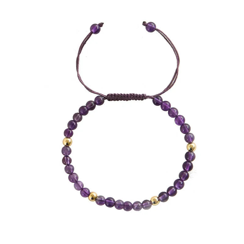 Handmade 4mm natural amethyst bracelet with 14K gold plated accents on a white background
