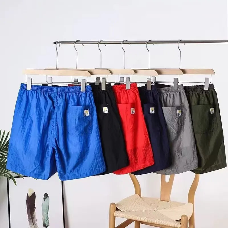 Men's quick-drying polyester blend sports shorts in blue with straight leg, available in multiple sizes