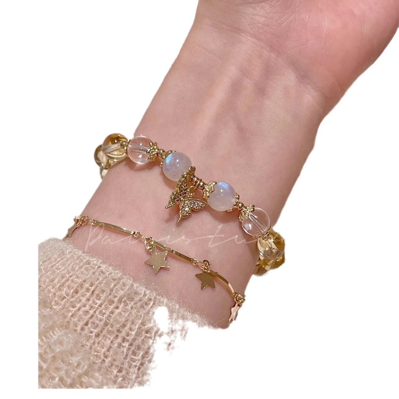 Moonstone white crystal beaded bracelet with citrine butterfly charm on display