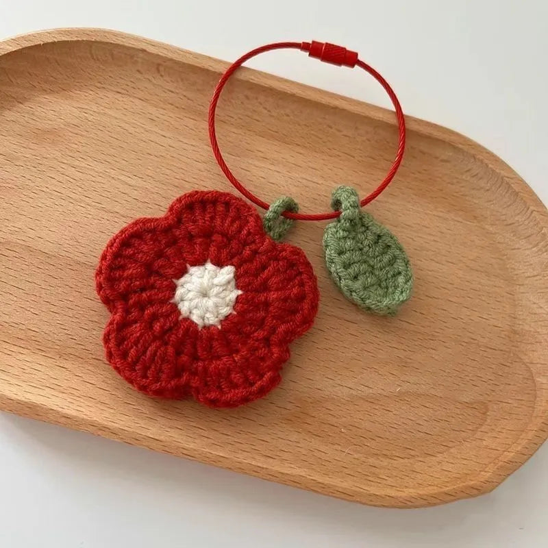 Pure hand crochet finished knitting wool plush small red flower pendant on white background