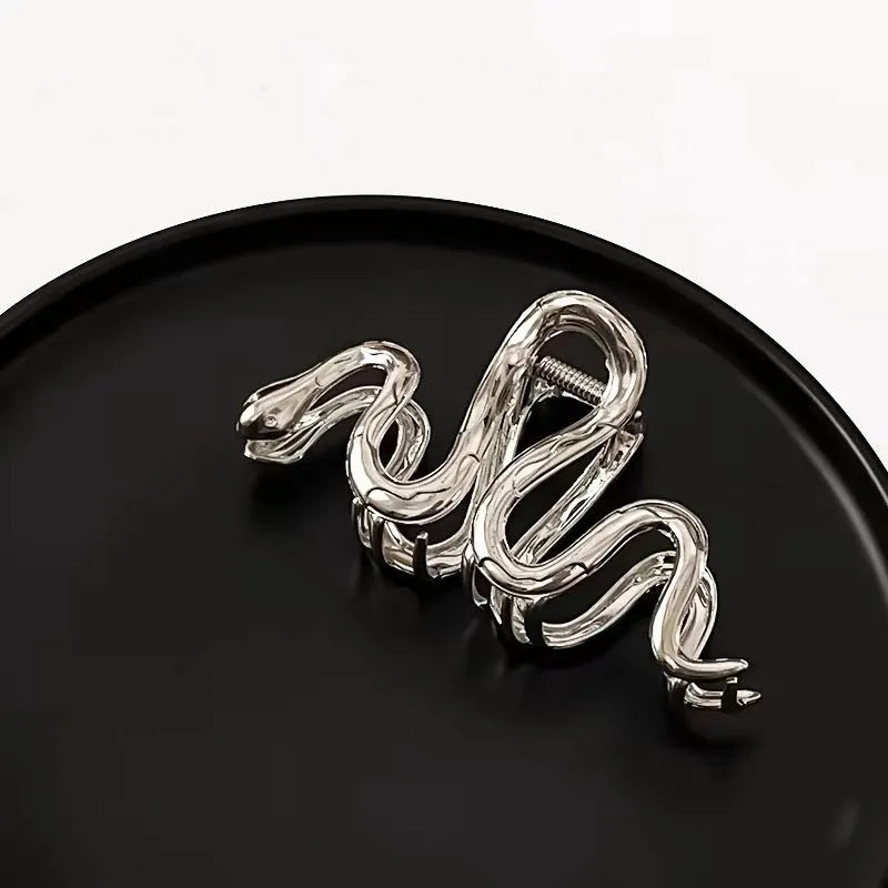 Slytherin serpentine metal hair clip in silver, 10.5cm, on flat surface