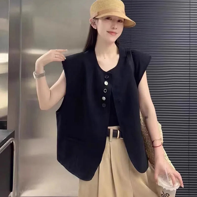 Women's loose-fit sleeveless polyester vest in black with visible pocket detail on the front.