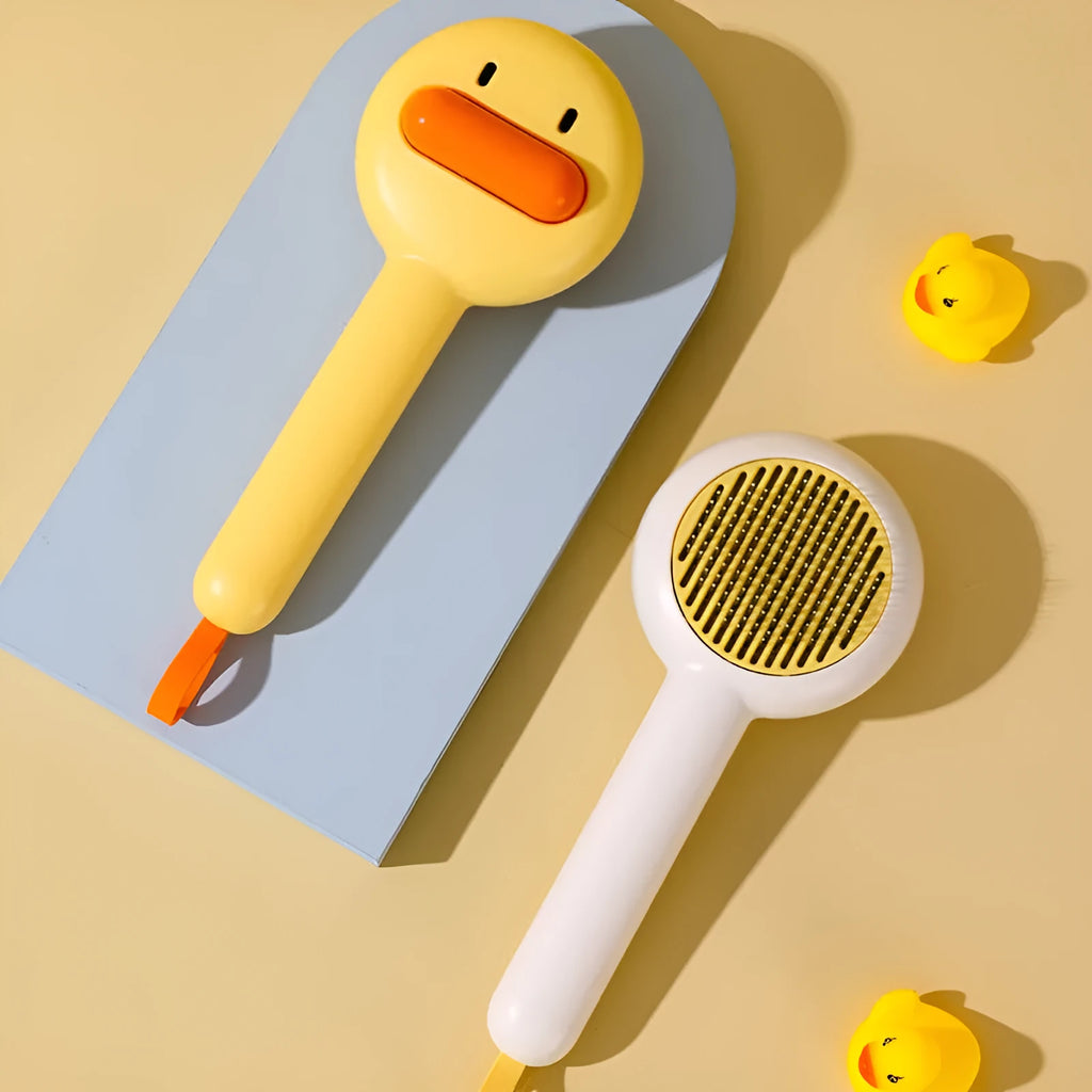 Small yellow duck pet grooming comb with fine needles and open section hair collection design