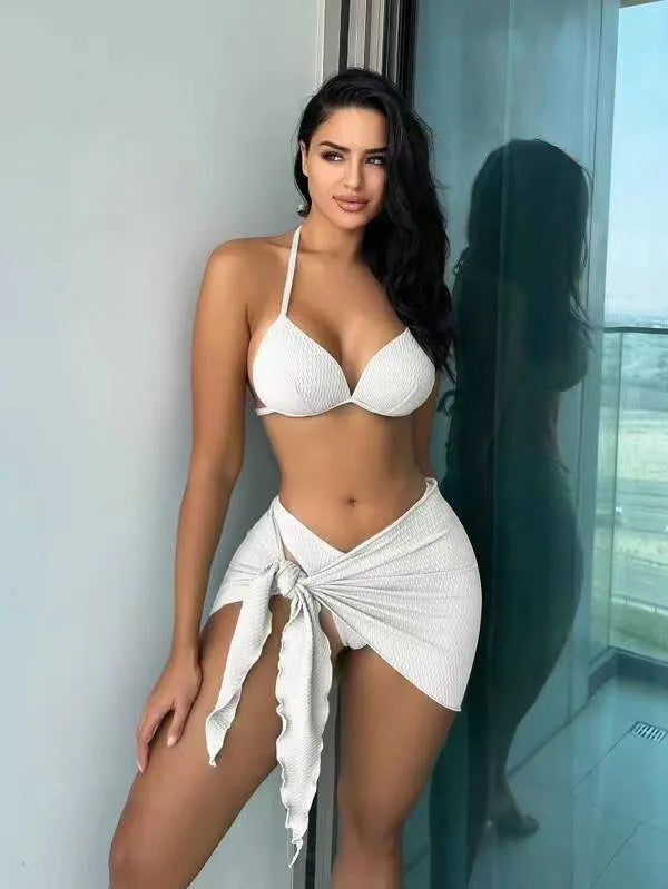 Women's black three-piece swimsuit set with bikini top, panties, and a Russian split skirt laid flat.