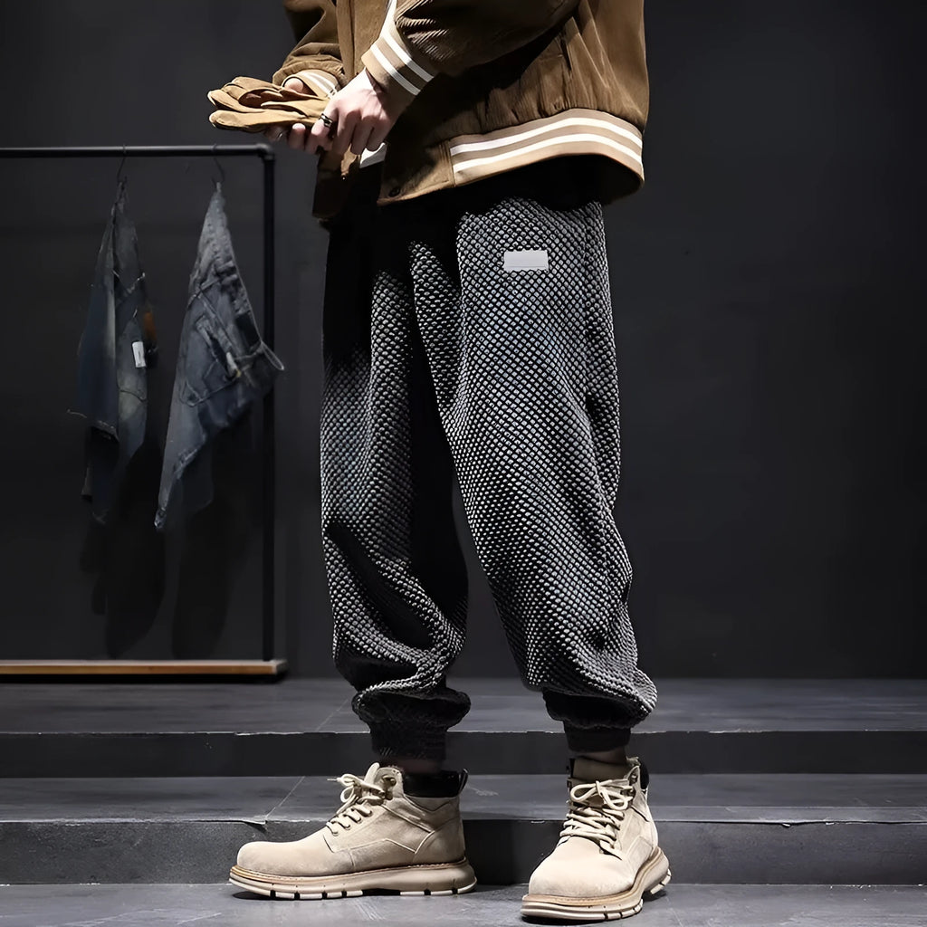 Grey men's casual sweatpants with ankle tie fastening and straight leg on a neutral background.